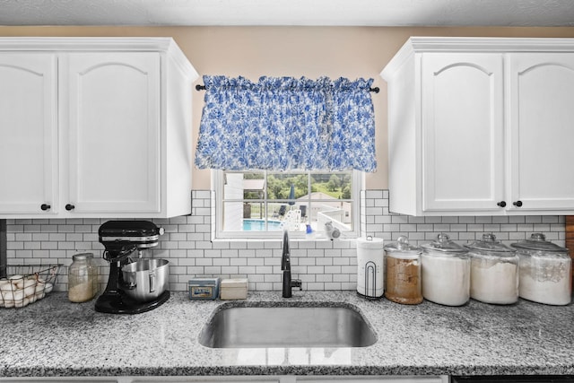 997 Copper Creek Rd, Berea, KY 40403 - kitchen with white cabinets, decorative backsplash, and light stone countertops