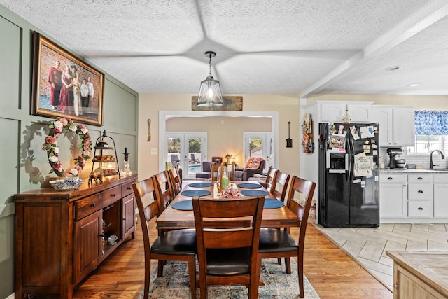 997 Copper Creek Rd, Berea, KY 40403 - dining room featuring french doors, a textured ceiling, and light wood-style flooring