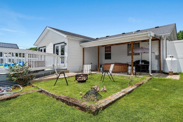997 Copper Creek Rd, Berea, KY 40403 - back of house with a hot tub, an outdoor fire pit, a deck, and a lawn