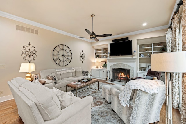 30 Woodburn St, Frankfort, KY 40601 - living area with a ceiling fan, crown molding, a premium fireplace, wood finished floors, and built in features