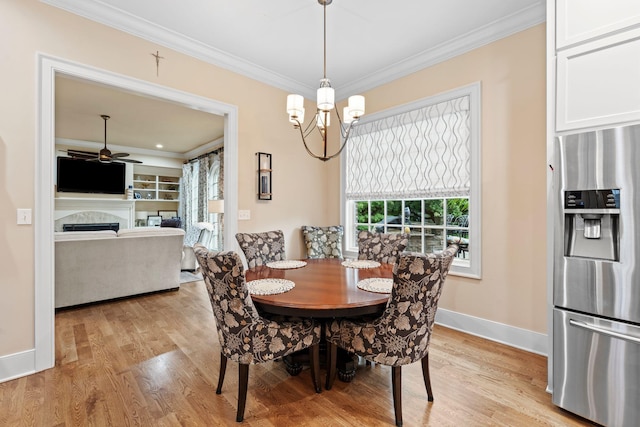 30 Woodburn St, Frankfort, KY 40601 - dining room featuring crown molding, light wood-style floors, a fireplace, a chandelier, and a ceiling fan