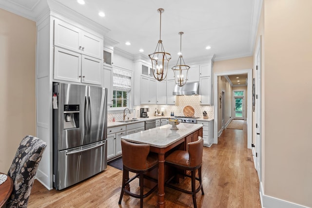 30 Woodburn St, Frankfort, KY 40601 - kitchen featuring appliances with stainless steel finishes, under cabinet range hood, crown molding, decorative backsplash, and a chandelier