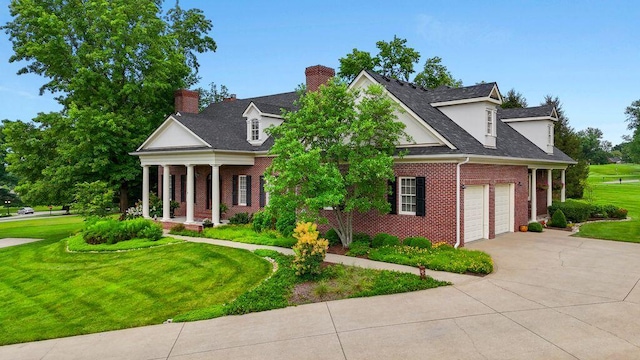 30 Woodburn St, Frankfort, KY 40601 - neoclassical / greek revival house featuring brick siding, concrete driveway, a front lawn, a chimney, and a garage