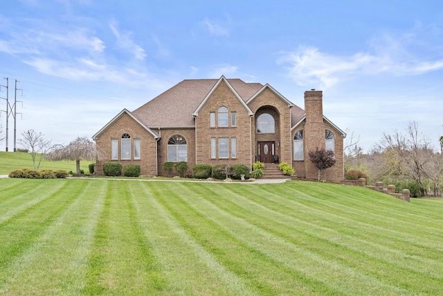 117 Richland Dr, Richmond, KY 40475 - traditional-style home with a front lawn, brick siding, and a chimney