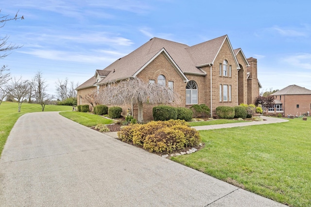 117 Richland Dr, Richmond, KY 40475 - view of front facade with brick siding, a front yard, and a shingled roof