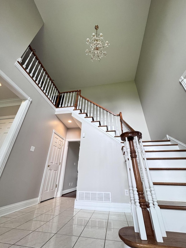 117 Richland Dr, Richmond, KY 40475 - staircase with a chandelier, a towering ceiling, and tile patterned flooring