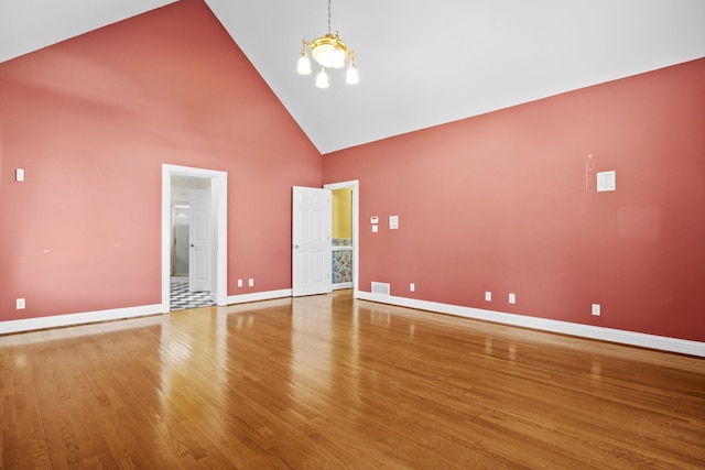 117 Richland Dr, Richmond, KY 40475 - empty room with high vaulted ceiling, a chandelier, and wood finished floors