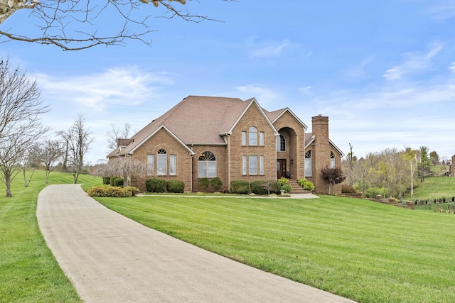 117 Richland Dr, Richmond, KY 40475 - traditional-style house featuring brick siding, a front yard, and a chimney