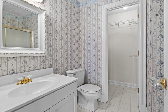 117 Richland Dr, Richmond, KY 40475 - bathroom featuring tile patterned flooring, a walk in closet, vanity, a shower with door, and wallpapered walls