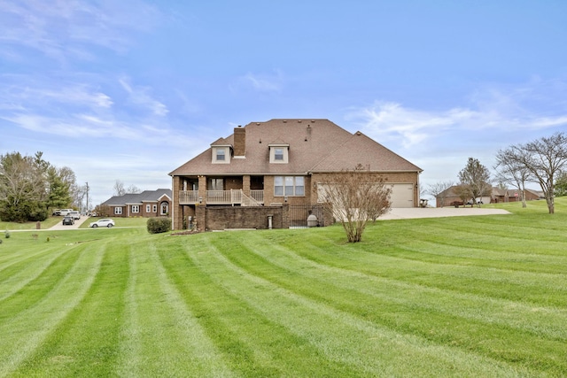 117 Richland Dr, Richmond, KY 40475 - back of property with driveway, a yard, an attached garage, brick siding, and a balcony