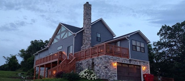 5134 Peaks Mill Rd, Frankfort, KY 40601 - view of side of home with a chimney, a garage, stairs, a deck, and stone siding