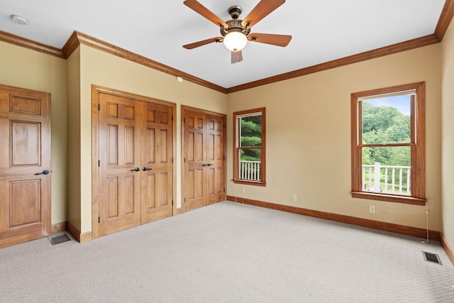 11238 Campton Rd, Stanton, KY 40380 - unfurnished bedroom featuring light carpet, multiple closets, crown molding, and a ceiling fan