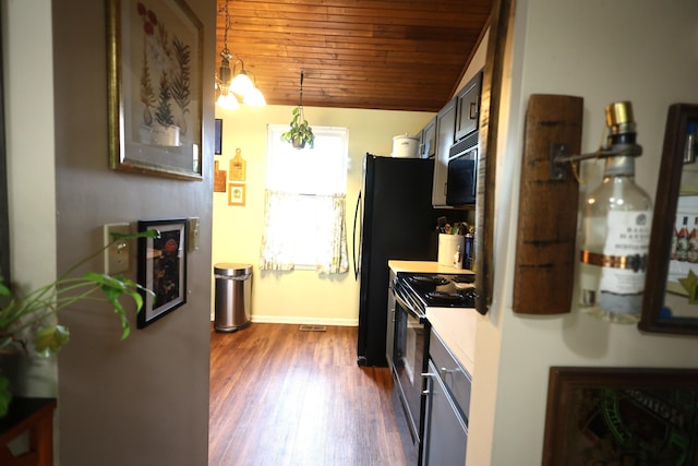 3645 Squire Woods Way, Lexington, KY 40515 - kitchen with stainless steel electric range, wooden ceiling, black microwave, light countertops, and dark wood-style floors