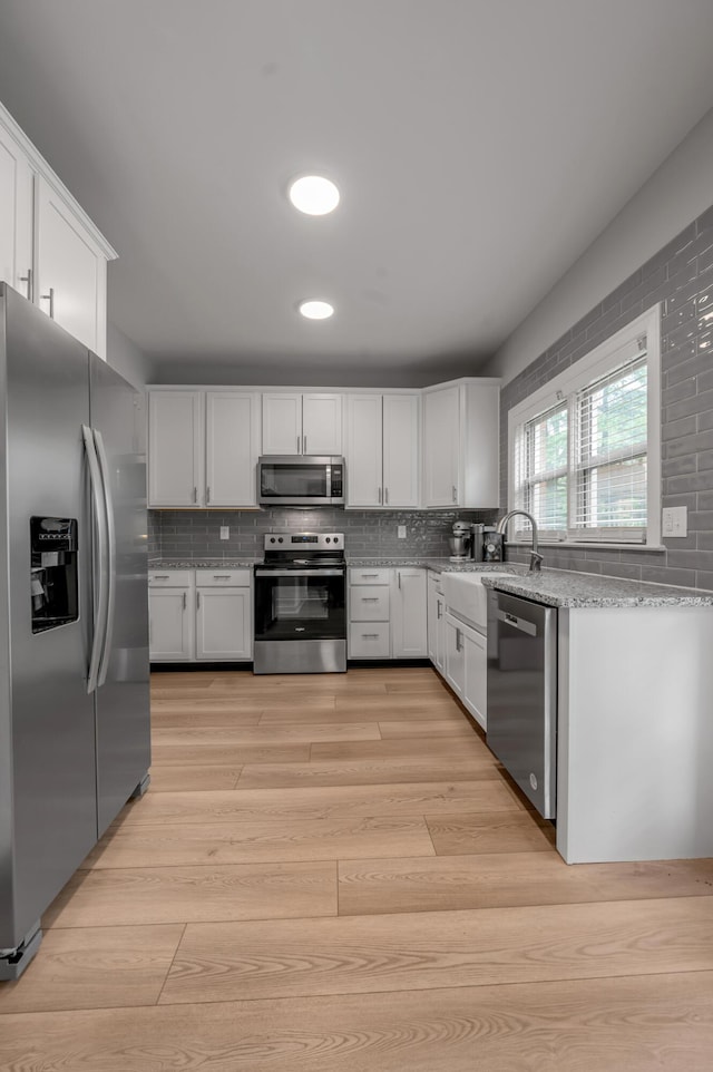 1074 Rockbridge Rd, Lexington, KY 40515 - kitchen featuring stainless steel appliances, white cabinets, tasteful backsplash, light stone countertops, and recessed lighting