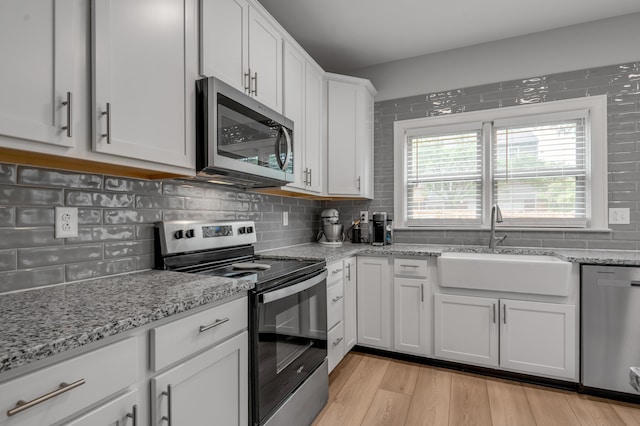 1074 Rockbridge Rd, Lexington, KY 40515 - kitchen with appliances with stainless steel finishes, decorative backsplash, and white cabinetry