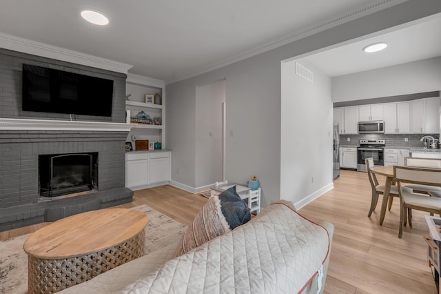 1074 Rockbridge Rd, Lexington, KY 40515 - living area with light wood-type flooring, a fireplace, and ornamental molding