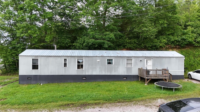 697 Ky 3439, Barbourville, KY 40906 - back of house with a trampoline, crawl space, a metal roof, and a lawn