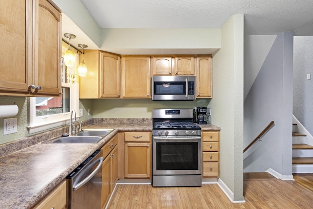 3523 Brookview Dr, Lexington, KY 40517 - kitchen with stainless steel appliances, light wood-style flooring, pendant lighting, and light brown cabinetry
