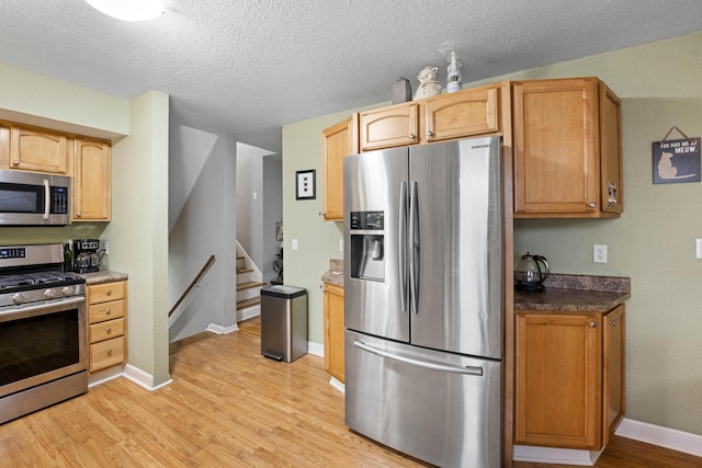 3523 Brookview Dr, Lexington, KY 40517 - kitchen with appliances with stainless steel finishes, light wood-type flooring, a textured ceiling, and dark countertops