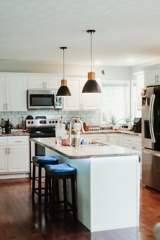 585 Cotton Rd, Corbin, KY 40701 - kitchen with appliances with stainless steel finishes, backsplash, and white cabinetry