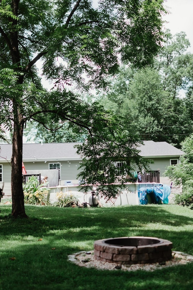 585 Cotton Rd, Corbin, KY 40701 - view of green lawn with an outdoor fire pit, a patio, and an outdoor pool