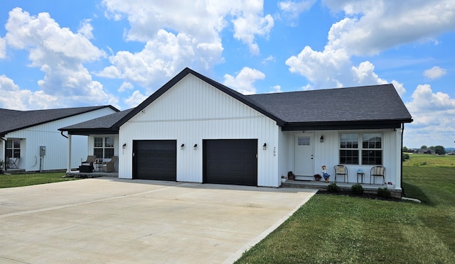 209-211 Wyldwood Way, Berea, KY 40403 - modern farmhouse featuring a garage, a front yard, concrete driveway, covered porch, and roof with shingles