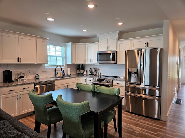 209-211 Wyldwood Way, Berea, KY 40403 - kitchen with stainless steel appliances, white cabinets, dark wood finished floors, backsplash, and recessed lighting