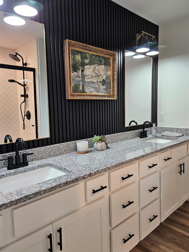 209-211 Wyldwood Way, Berea, KY 40403 - bathroom featuring wallpapered walls, double vanity, wood finished floors, and a tile shower