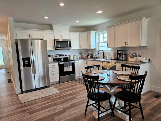 209-211 Wyldwood Way, Berea, KY 40403 - kitchen with stainless steel appliances, white cabinetry, dark wood-type flooring, recessed lighting, and backsplash