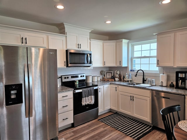 209-211 Wyldwood Way, Berea, KY 40403 - kitchen with stainless steel appliances, white cabinets, light stone countertops, decorative backsplash, and recessed lighting