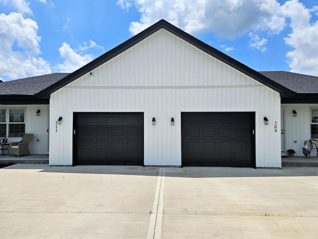 209-211 Wyldwood Way, Berea, KY 40403 - view of side of home featuring driveway, roof with shingles, and a garage
