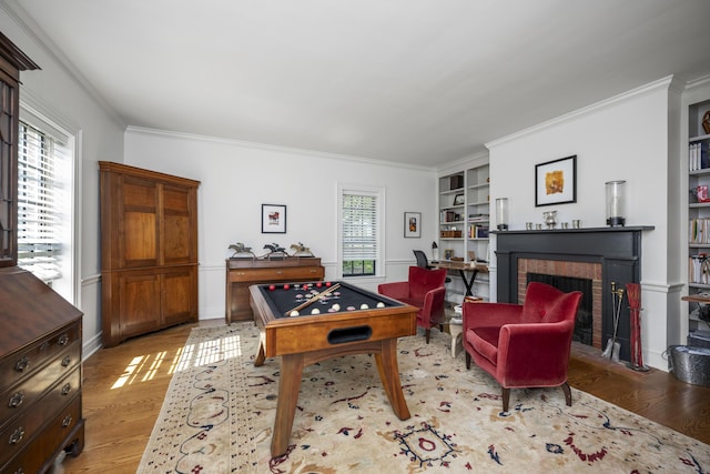 321 S Turner St, Midway, KY 40347 - playroom featuring a fireplace, crown molding, light wood-style floors, and built in shelves