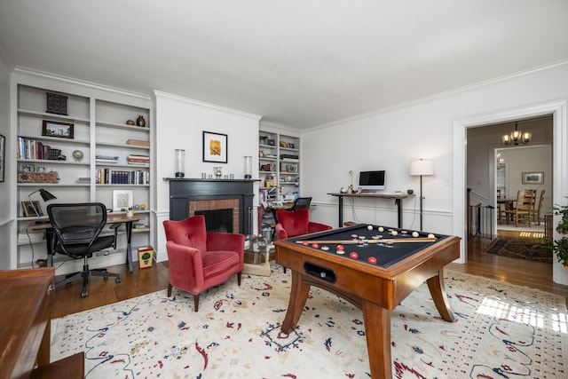 321 S Turner St, Midway, KY 40347 - playroom featuring a chandelier, ornamental molding, wood finished floors, a fireplace, and built in shelves