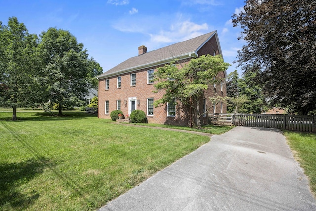 321 S Turner St, Midway, KY 40347 - colonial-style house featuring brick siding, a chimney, and asphalt driveway
