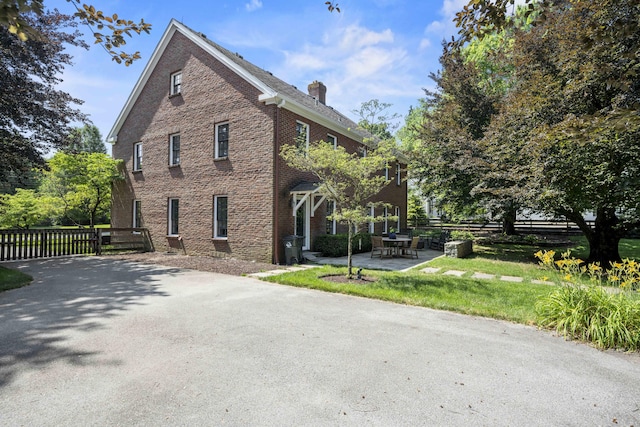 321 S Turner St, Midway, KY 40347 - view of side of property with a chimney, brick siding, and a patio area