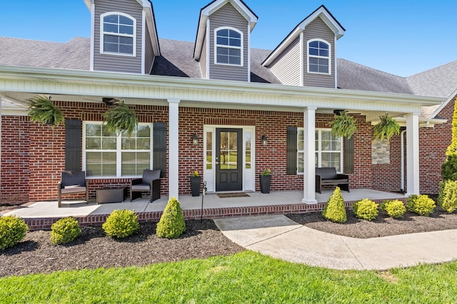 111 Colonial Dr, Versailles, KY 40383 - entrance to property with covered porch, brick siding, and a shingled roof