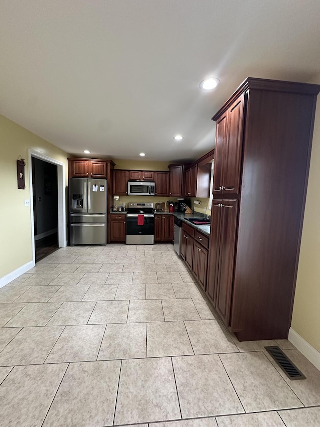 218 Foster Ln, Stanford, KY 40484 - kitchen featuring stainless steel appliances, recessed lighting, light tile patterned flooring, dark brown cabinetry, and dark countertops