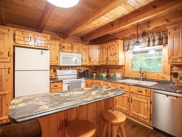 843 Joe Henson Rd, Dunnville, KY 42528 - kitchen with white appliances, a wooden ceiling with exposed beams, dark wood-style flooring, a breakfast bar, and a center island