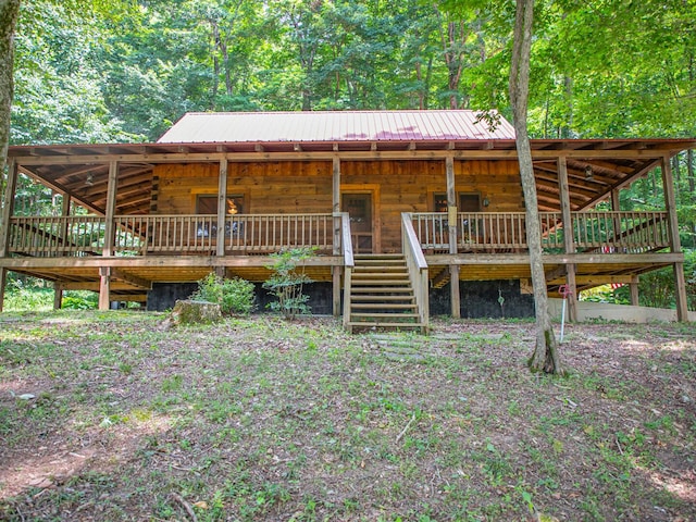 843 Joe Henson Rd, Dunnville, KY 42528 - log cabin with stairs, a metal roof, a wooden deck, and log siding