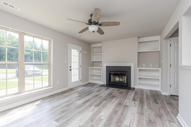321 Houston Creek Dr, Paris, KY 40361 - unfurnished living room with light wood-style floors, ceiling fan, built in shelves, and a fireplace