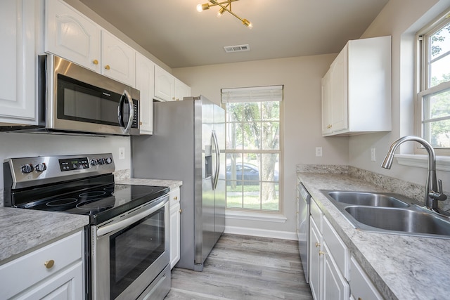 321 Houston Creek Dr, Paris, KY 40361 - kitchen with appliances with stainless steel finishes, white cabinetry, light wood-style flooring, and light countertops