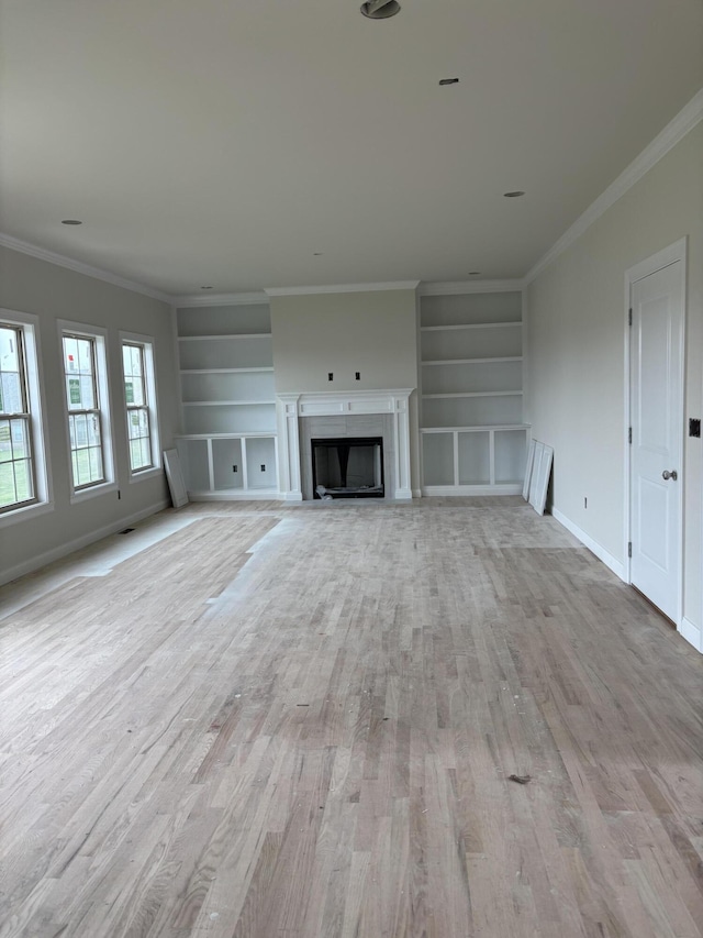 2716 Kearney Creek Ln, Lexington, KY 40511 - unfurnished living room featuring built in features, light wood finished floors, crown molding, and a fireplace