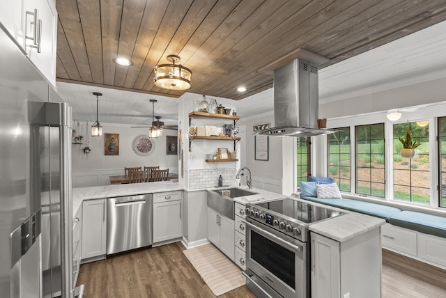 1020 Cornish Ln, Lawrenceburg, KY 40342 - kitchen with stainless steel appliances, island exhaust hood, wood ceiling, a peninsula, and light stone countertops