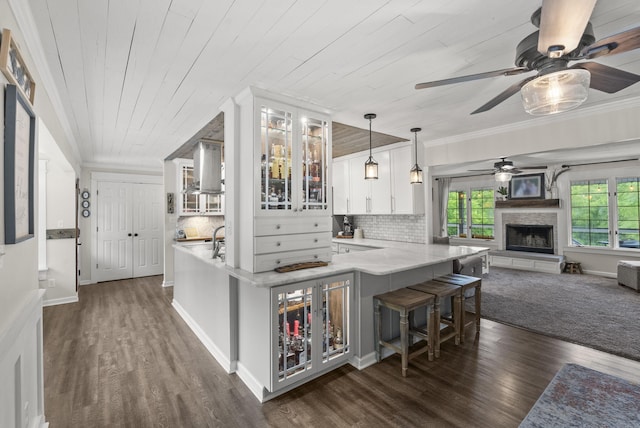 1020 Cornish Ln, Lawrenceburg, KY 40342 - kitchen featuring a ceiling fan, dark wood-style flooring, white cabinets, a kitchen bar, and wood ceiling