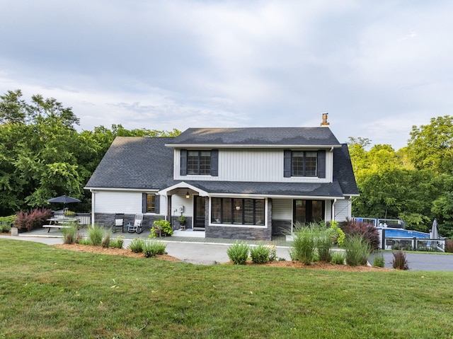 1020 Cornish Ln, Lawrenceburg, KY 40342 - view of front facade featuring a chimney, a front yard, a shingled roof, and stone siding