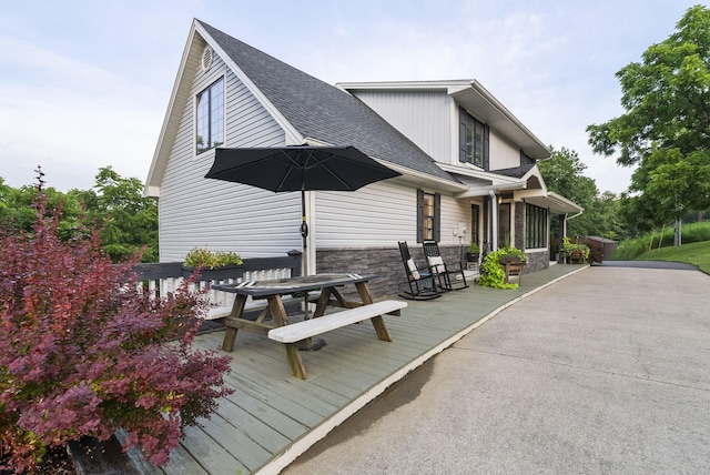 1020 Cornish Ln, Lawrenceburg, KY 40342 - rear view of property featuring a shingled roof, outdoor dining area, stone siding, and a wooden deck