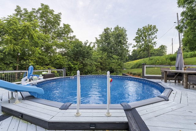 1020 Cornish Ln, Lawrenceburg, KY 40342 - swimming pool featuring a wooden deck, a water slide, and view of wooded area
