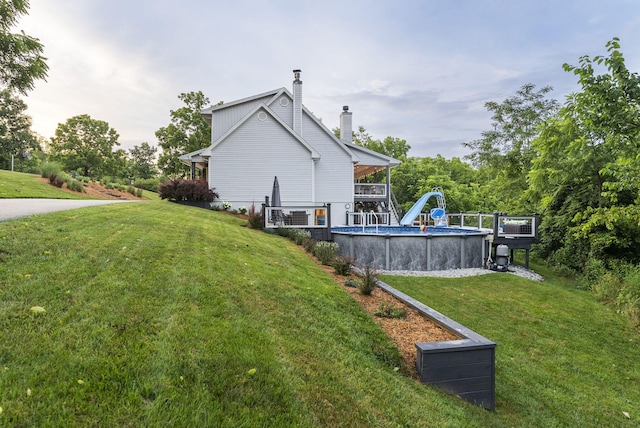 1020 Cornish Ln, Lawrenceburg, KY 40342 - rear view of property featuring a chimney, a lawn, and an outdoor pool
