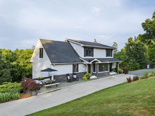 1020 Cornish Ln, Lawrenceburg, KY 40342 - view of front of property with stone siding, a chimney, a front yard, a shingled roof, and a porch