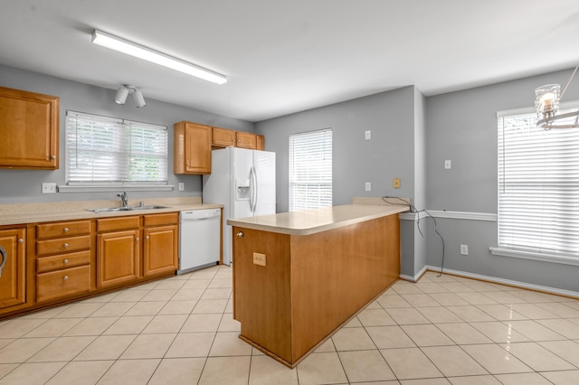 2916 Sandersville Rd, Lexington, KY 40511 - kitchen featuring white appliances, a peninsula, light countertops, light tile patterned floors, and brown cabinets
